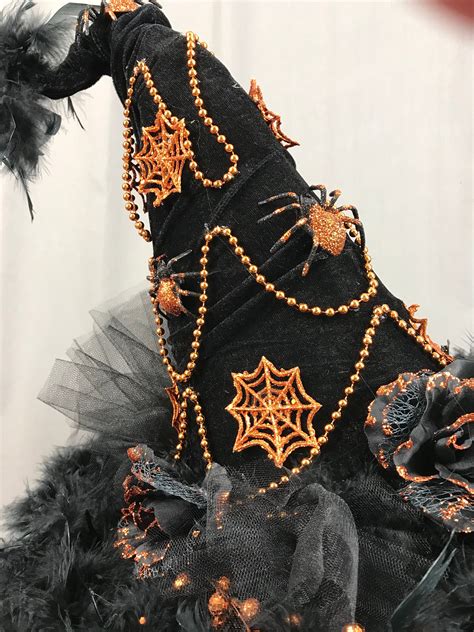 Witch hat embellished with spider web details